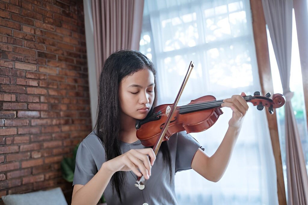 Home asian girl playing violin alone room 8595 15891 picsart aiimageenhancer